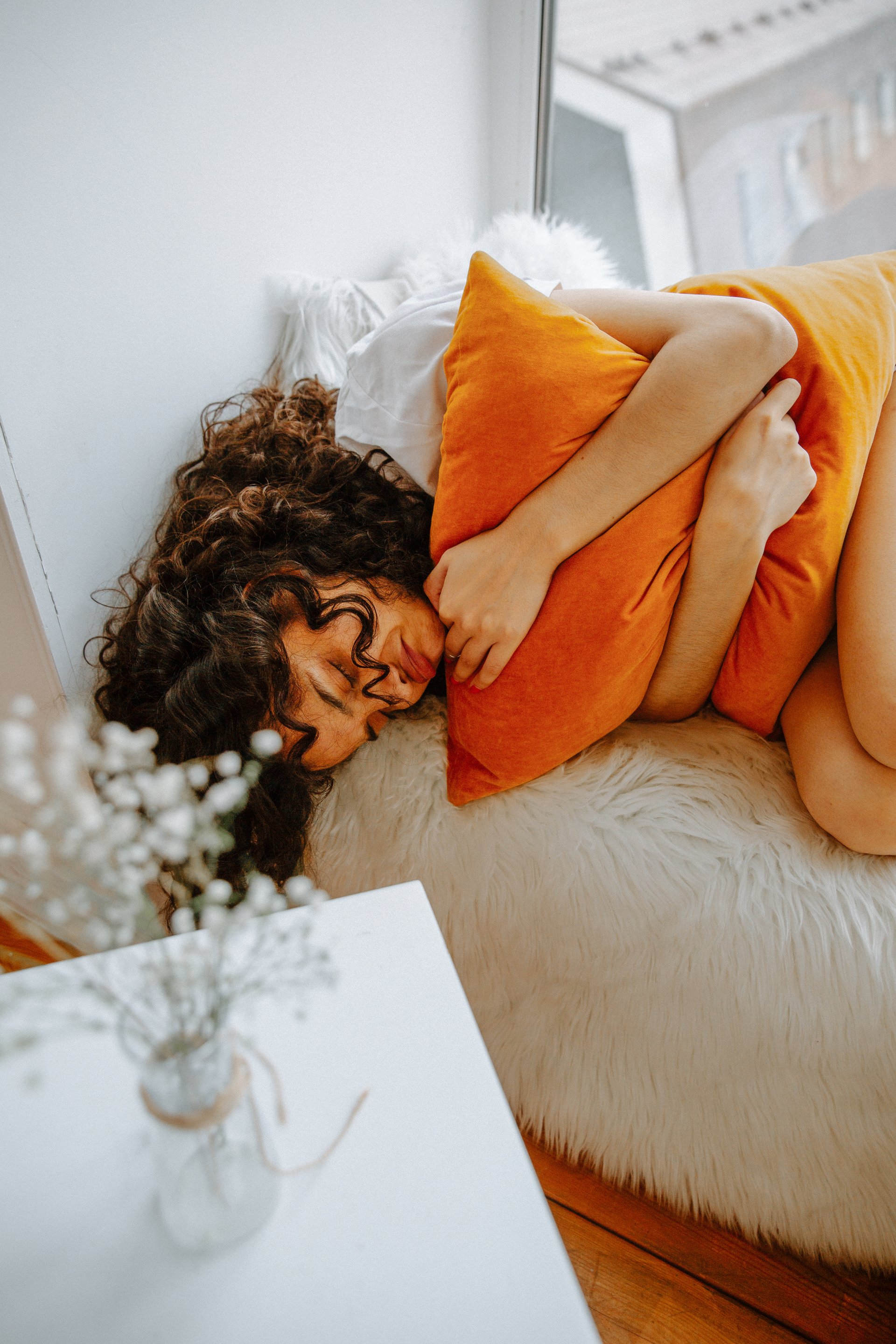 Woman Curled Up in Bed